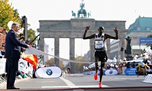 Dennis Kimetto of Kenya crosses the finish line in new world record time